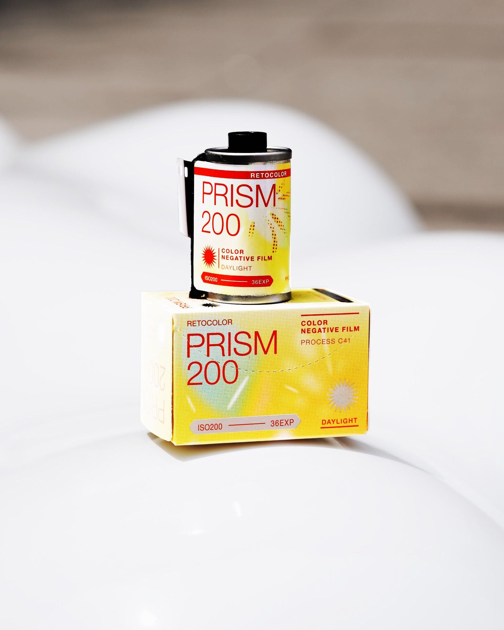 Two boxes of Kodak Prism 200 color negative film on a white surface.